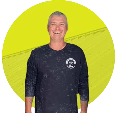 Ricky Jenner, owner of Ricky Jenner Roofing, smiling in a dark work shirt