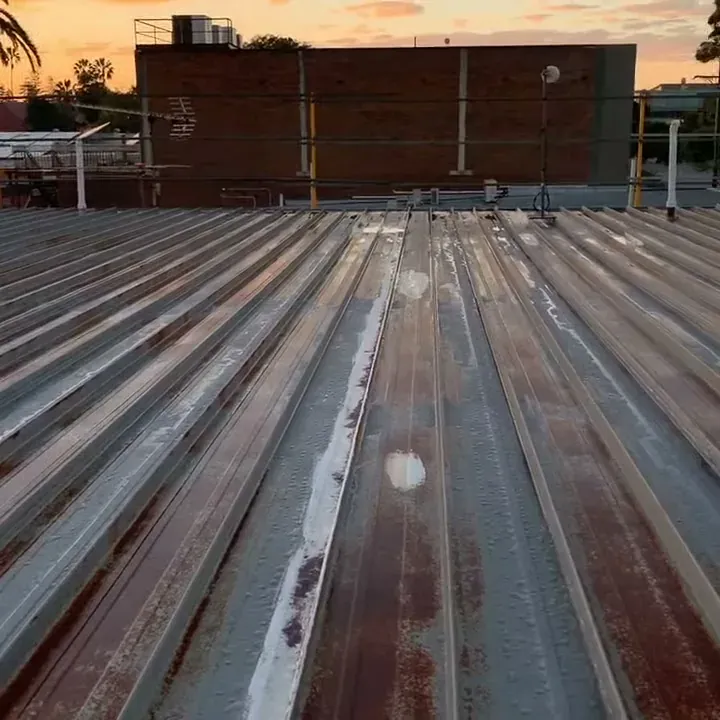 Rusted clip-lock roof sheets before replacement in Ballina