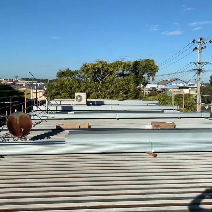 New clip-lock roof sheets laid out across the old roof during a Ballina re-roof