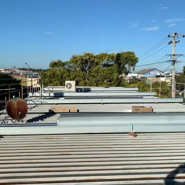 New clip-lock roof sheets laid out across the old roof during a Ballina re-roof
